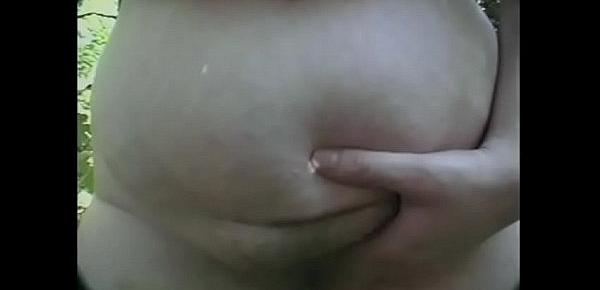 Naughty bbw with big tits gives a guy a blowjob in the forest, and her friend masturbates on the grass